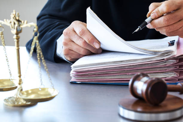 Scales of justice with judge gavel on table